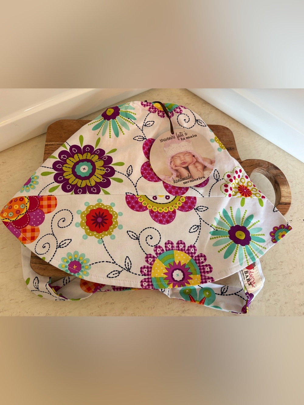 handmade baby sun hat or bonnet made from colorful floral cotton fabric featurin